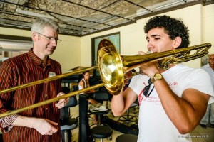 Principal Trombone Doug Wright works with a young trombonist at Instituto Superior de Arte in Havana. Wright subsequently gave the young man two mouthpieces for his instrument.  Photo by Travis Anderson